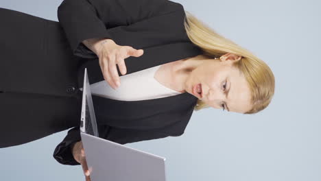Vertical-video-of-Business-woman-looking-at-laptop-getting-frustrated.-Sad-and-helpless.